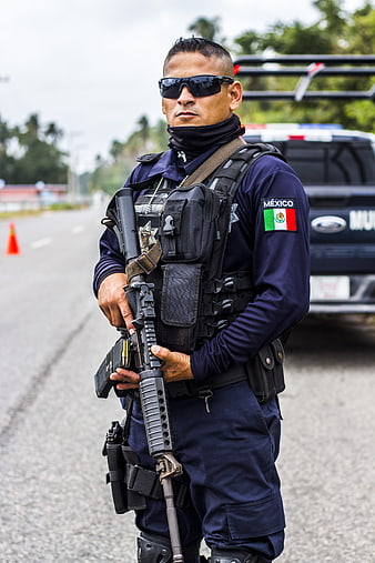 Armed Mexican Federal Police Officer Standing On Road