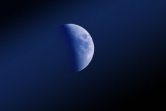 Blue-tinted gibbous moon against a dark night sky