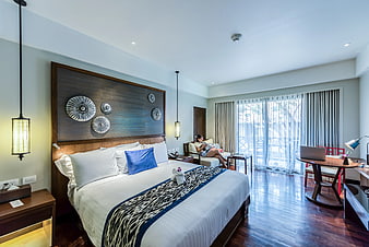 Modern Hotel Bedroom Interior with Woman Relaxing