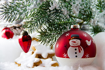 Red Christmas Ornaments and Gingerbread Cookies on Snow