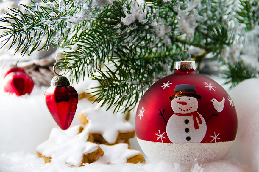 Red Christmas Ornaments and Gingerbread Cookies on Snow