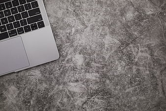 Silver Laptop on Textured Concrete Surface with Copyspace