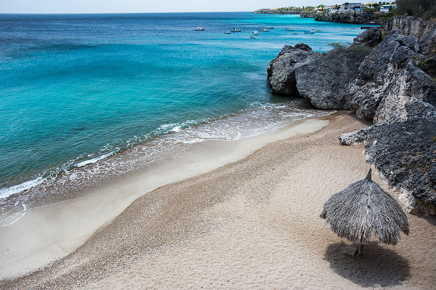 Tropical Beach with Turquoise Water and Thatched Umbrella