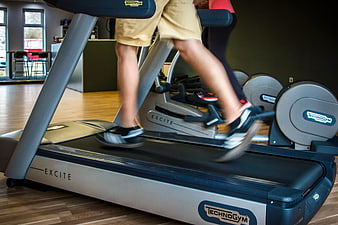 Close-up of legs running on Technogym treadmill in gym