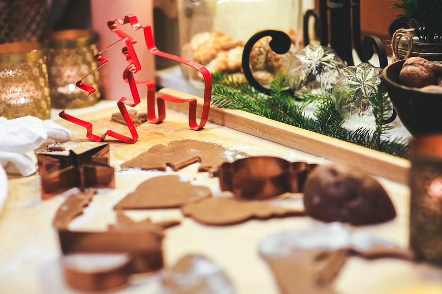 Christmas Cookie Cutters and Gingerbread Dough on Wooden Board