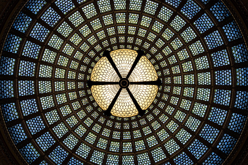 Ornate stained glass dome ceiling with central chandelier