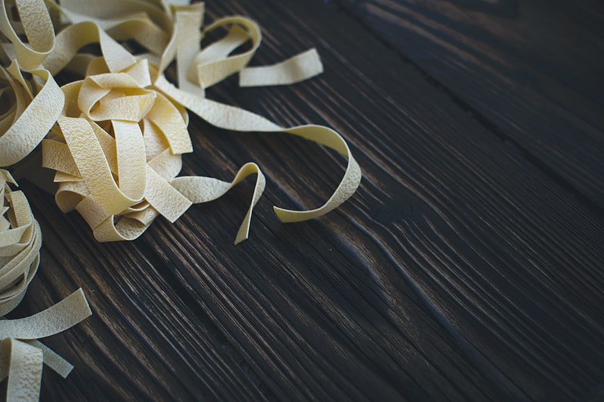 Fresh Tagliatelle Pasta on Dark Wooden Table