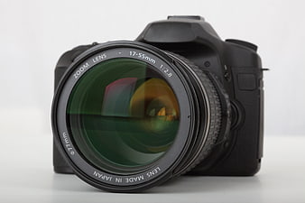 Black DSLR Camera With 17-55mm Zoom Lens On White Background