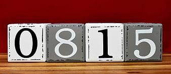 Wooden Blocks Displaying Number 0815 Against Red Background