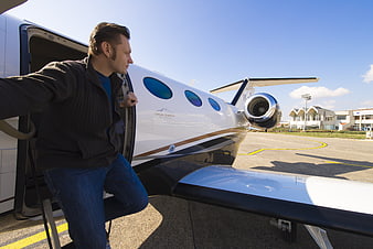 Man Boarding Private Jet On Airport Tarmac