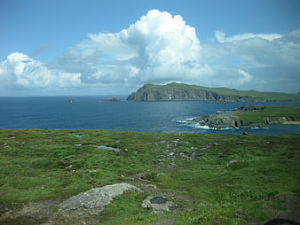 Scenic Irish Coastline with Green Hills and Blue Ocean