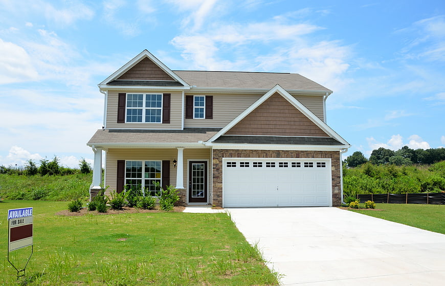 New suburban home for sale with driveway and lawn