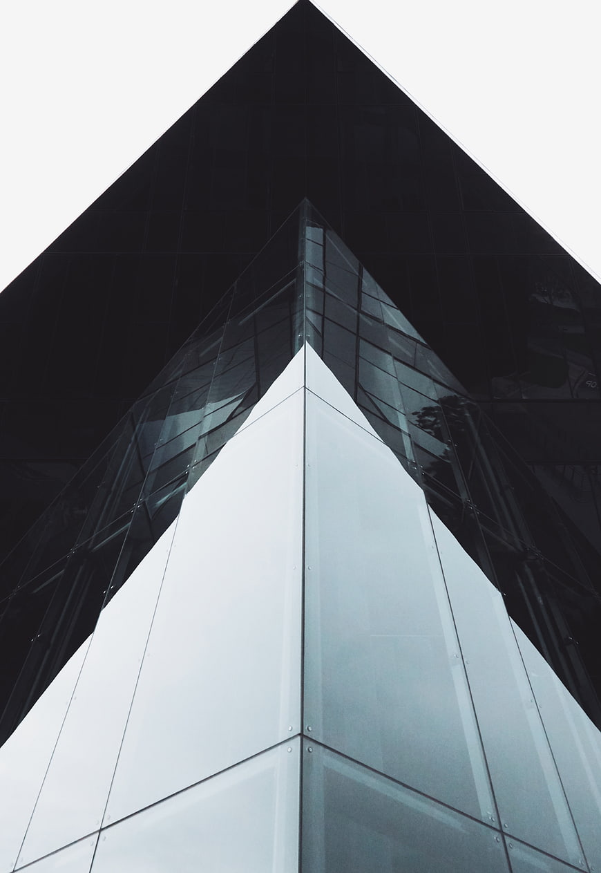 Low angle view of modern geometric glass skyscraper architecture