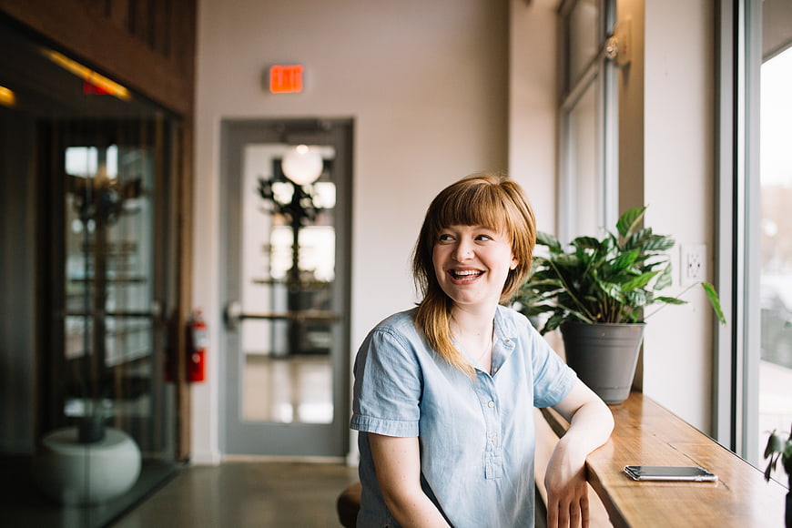 Happy woman smiling in modern office workspace