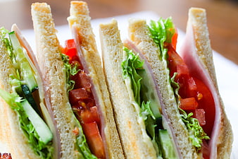 Close-up of fresh club sandwich with ham, lettuce, and tomato