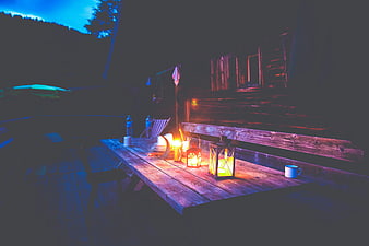 Cozy wooden deck with lanterns at night