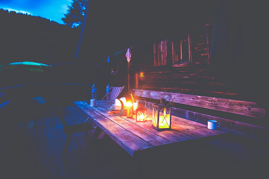 Cozy wooden deck with lanterns at night