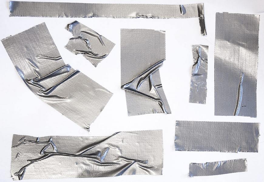 Silver duct tape pieces on white background