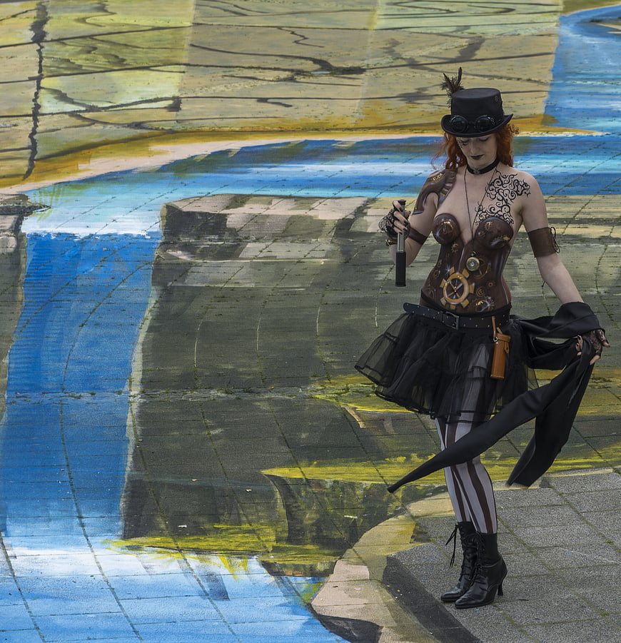 Steampunk woman posing on colorful 3D street art pavement
