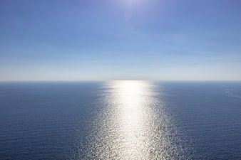 Aerial View of Calm Blue Ocean with Sun Reflection