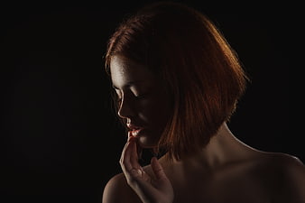 Moody Low-Key Portrait of Woman with Red Hair