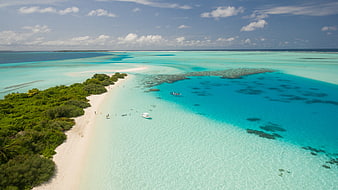 Aerial View of Tropical Island with Turquoise Lagoon and White Sand Beach