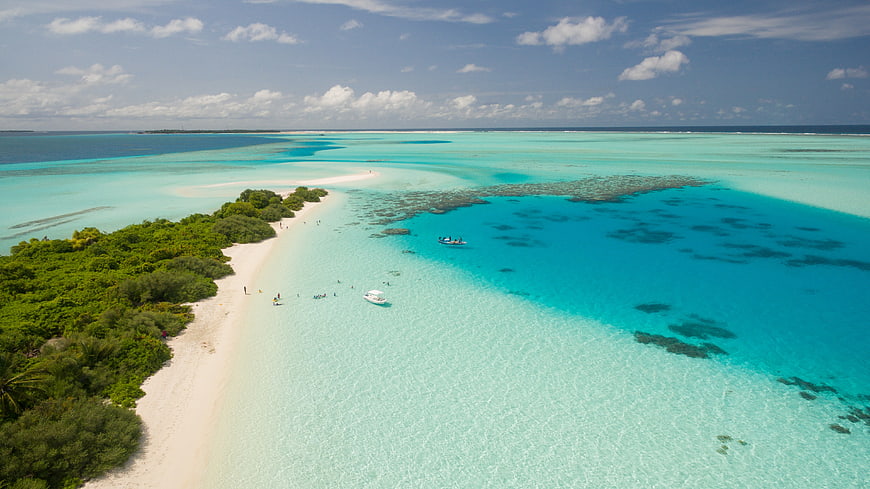 Aerial View of Tropical Island with Turquoise Lagoon and White Sand Beach