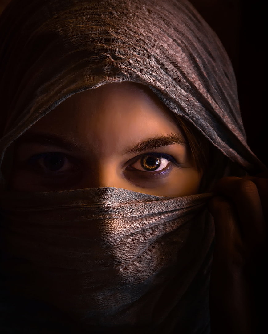 Close-up portrait of woman with headscarf and mysterious eyes