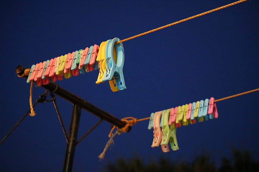 Colorful clothespins on a rope against a deep blue night sky