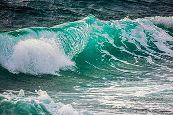 Turquoise Ocean Wave Breaking With White Sea Foam