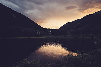 Dramatic sunset reflection on calm mountain lake