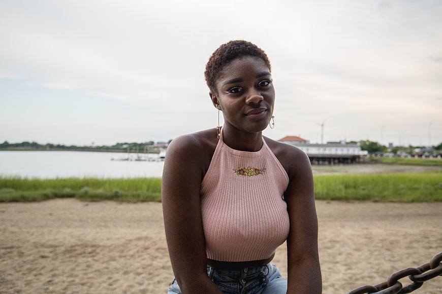 Portrait of young black woman sitting on beach