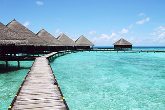 Overwater Bungalows on Wooden Pier in Turquoise Lagoon