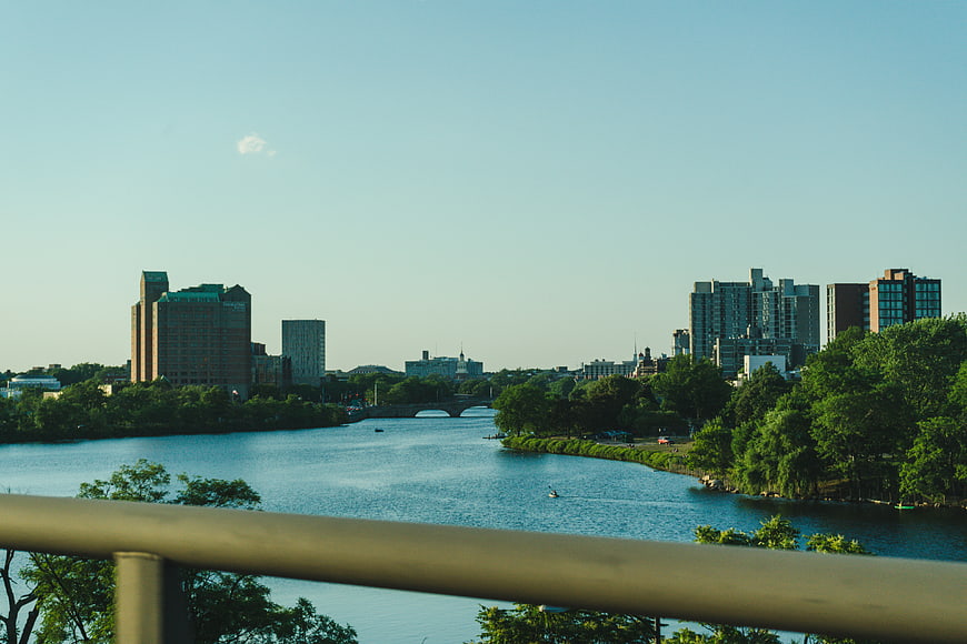 Boston skyline view over Charles River with bridge and greenery
