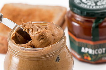 Open Jar of Peanut Butter with Knife and Toast