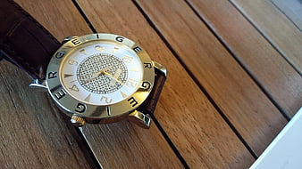 Gold and Silver Analog Watch on Wooden Surface