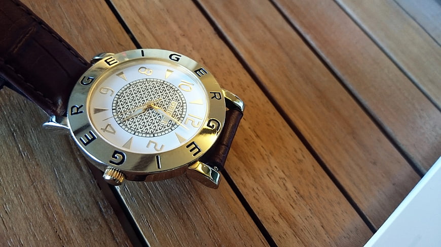 Gold and Silver Analog Watch on Wooden Surface