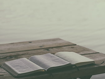 Open Bible on Wooden Dock by Lake