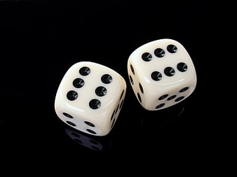Two white dice showing six on black background