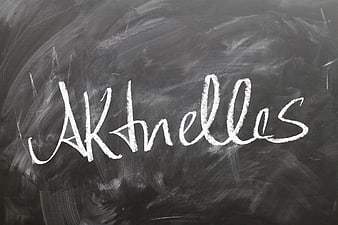 Greek word Akhelles written in white chalk on a dark blackboard