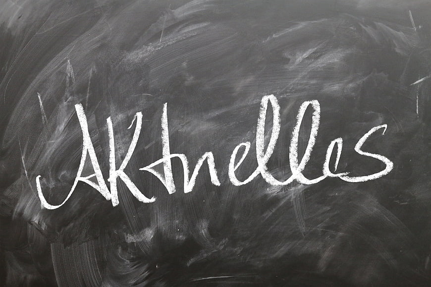 Greek word Akhelles written in white chalk on a dark blackboard