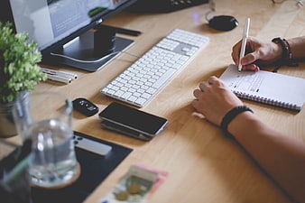 Web Designer Sketching Website Layout on Notebook