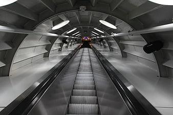 Futuristic Escalator Tunnel with Symmetrical Lighting