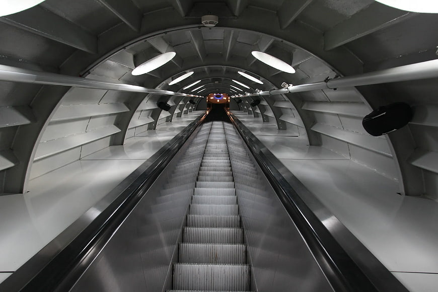 Futuristic Escalator Tunnel with Symmetrical Lighting