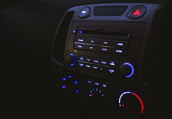 Close-up of car dashboard radio and climate controls at night
