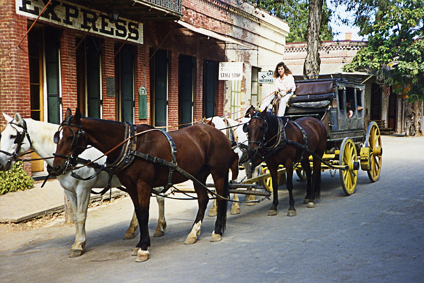 Vintage stagecoach with horses in old western town street