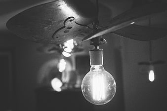 Vintage Ceiling Fan with Glowing Edison Bulb in Black and White