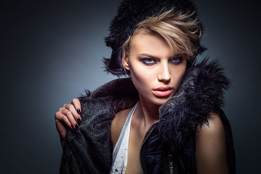 Studio Portrait of Woman in Black Fur Coat and Hat