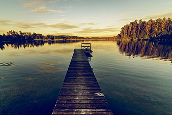 Serene Wooden Dock on Calm Lake at Sunset