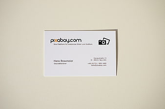 Minimalist white business card mockup on textured beige background